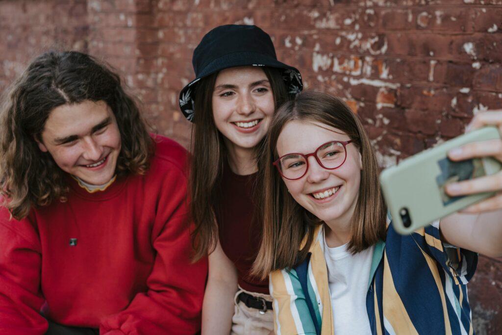 Teenagers taking group selfie